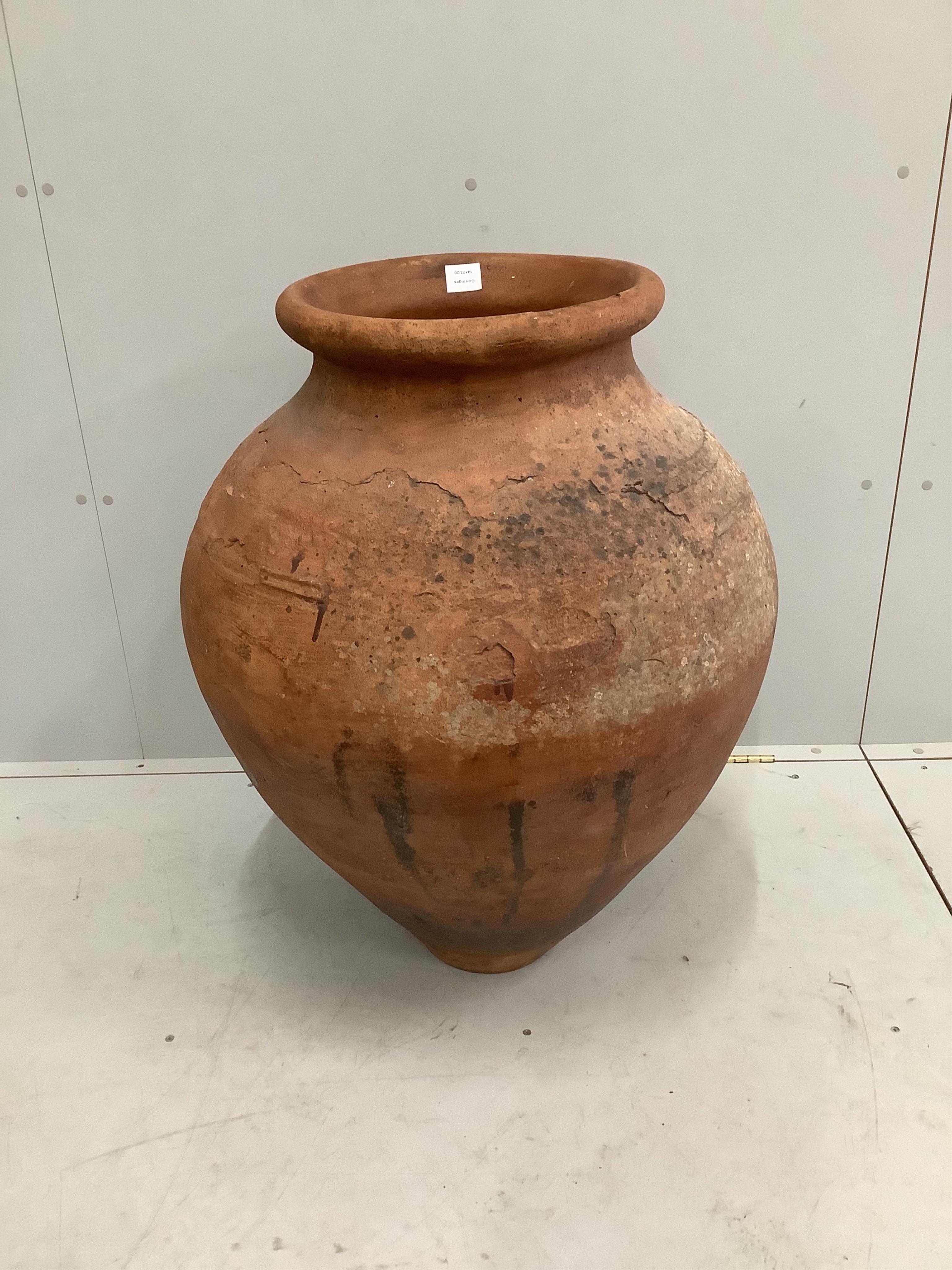 A large earthenware amphora, height 85cm. Condition - fair